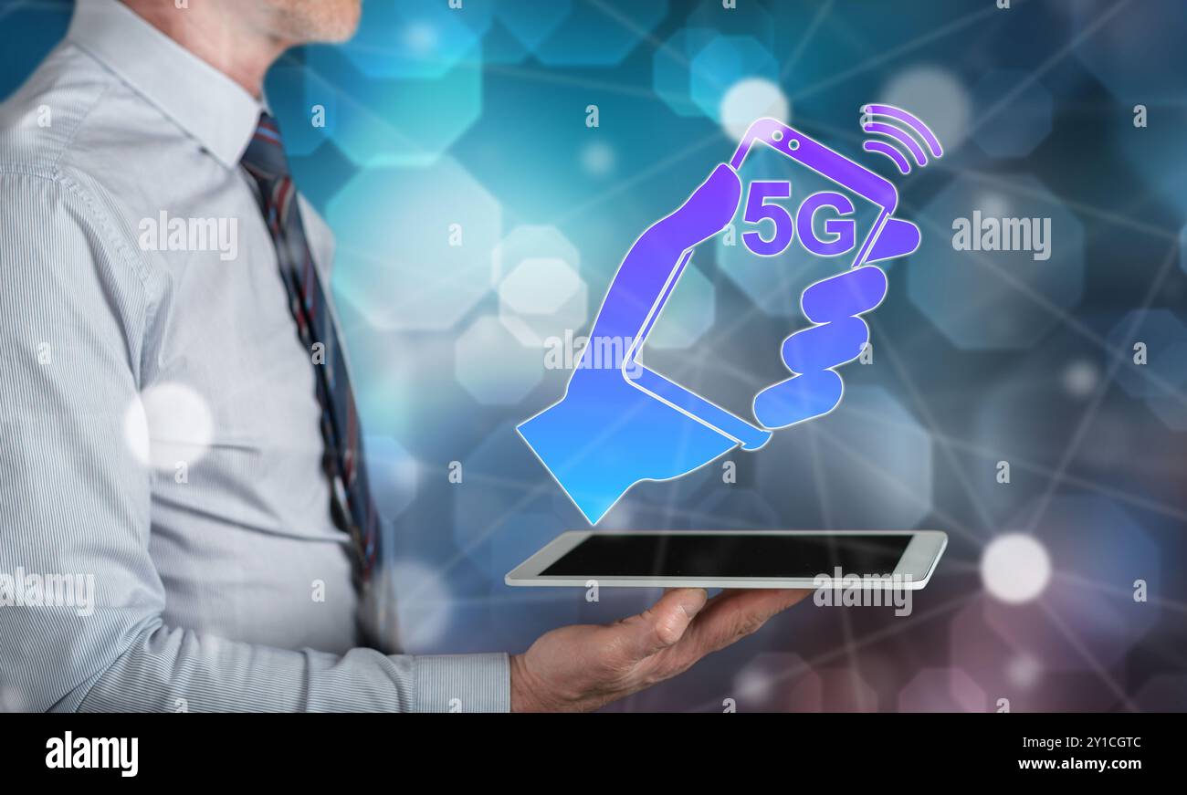 5g concept above a tablet held by a man Stock Photo