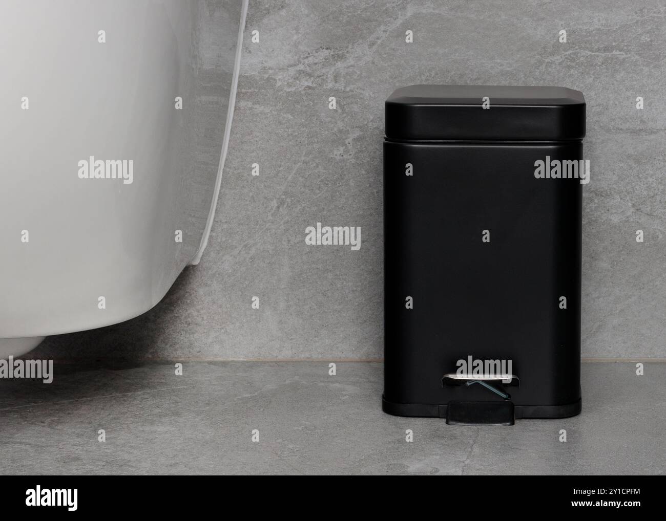 Compact Black Pedal Trash Bin in Minimalist Bathroom Stock Photo - Alamy