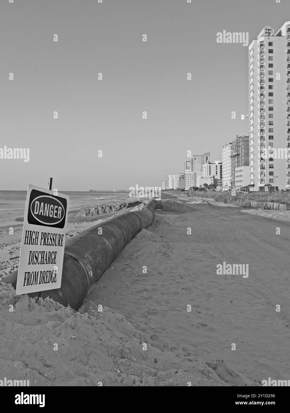 Danger sign warning near dredging pipeline at a beach restoration project in Myrtle Beach, South Carolina, USA. Stock Photo