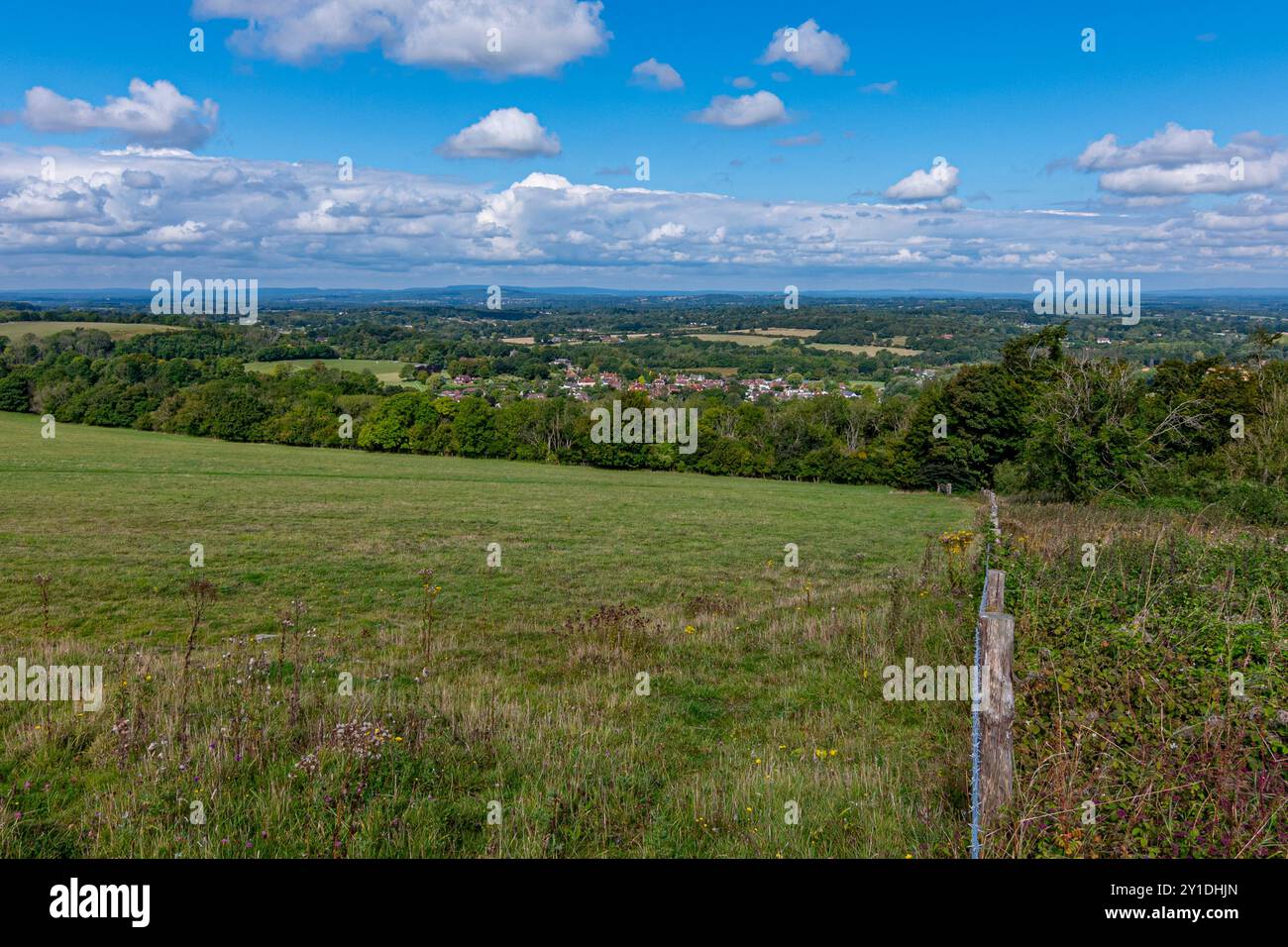 Looking the picturesque village of Washington and the Sussex Weald beyond, from Chanctonbury Hill in the South Downs National Park, W Sussex, UK. Stock Photo