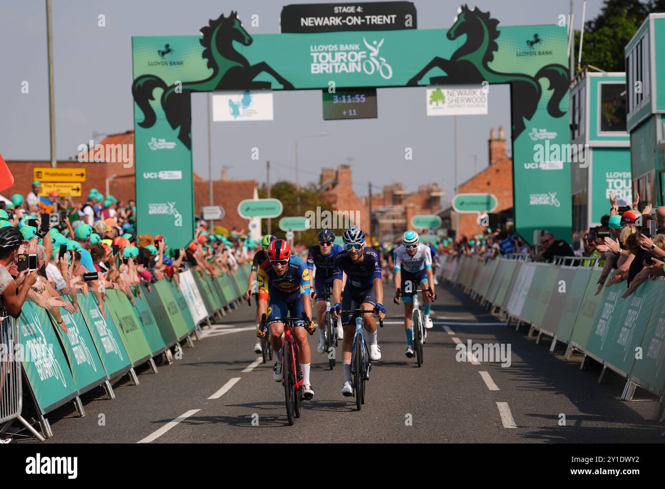 Riders pass the finish line during stage four of the 2024 Lloyds Bank
