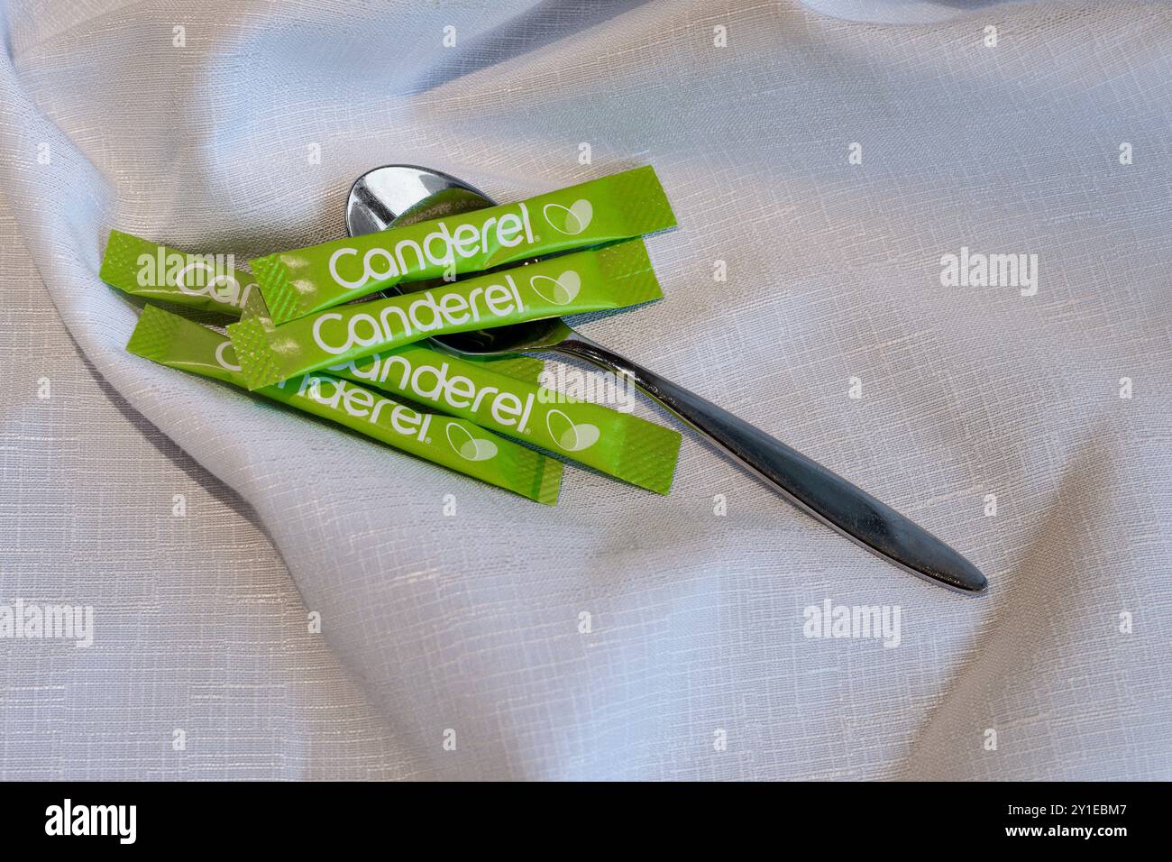 Kirkwall, Orkney, Scotland - July 16, 2024: Single serving stick packets of Canderel low calorie sweetener, made from extracts of the Stevia plant (St Stock Photo