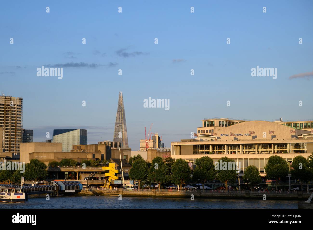 A riverside view of the Royal Festival Hall, Queen Elizabeth Hall and the Purcell Rooms with the Shard in the background seen from the Jubilee Footbri Stock Photo