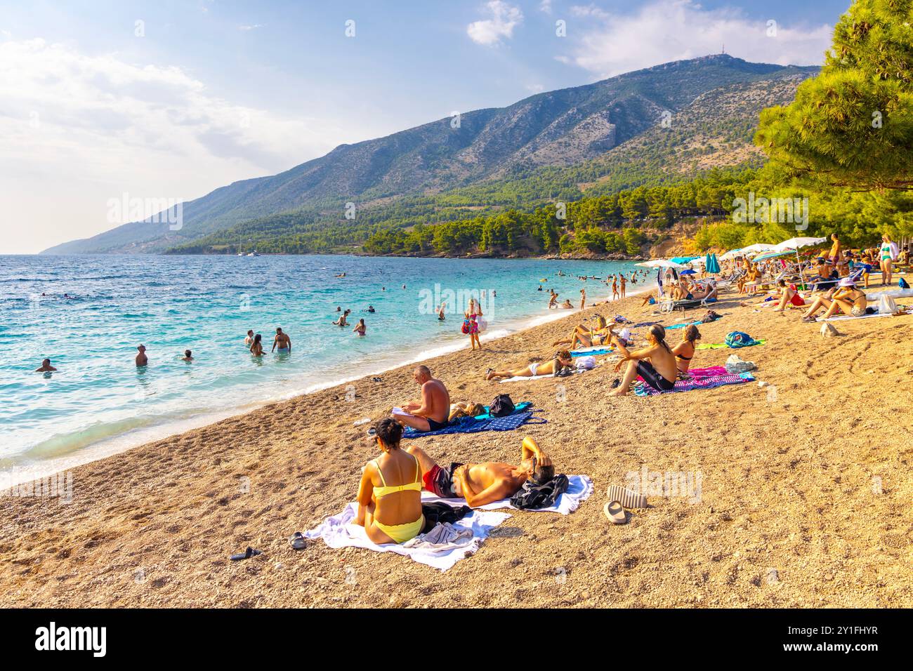 People swimming and sunbathing at the Golden Horn Beach (Zlatni Rat) on the Adriatic Sea, Brac, Croatia Stock Photo