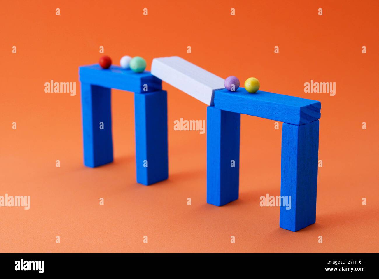Group of separate spheres in interrupted step of bridge made of wooden ...