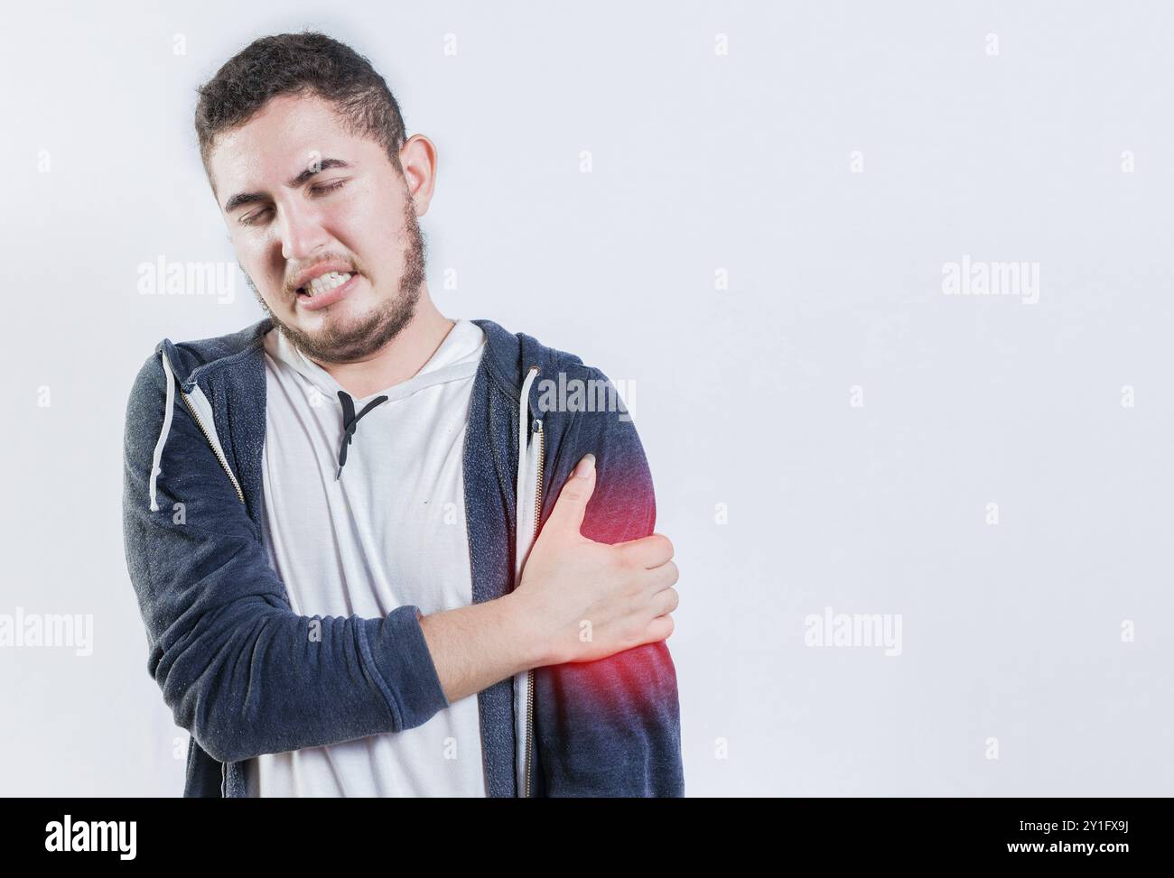 Unhappy man with arms muscle pain isolated. Sore young man with arms pain isolated Stock Photo