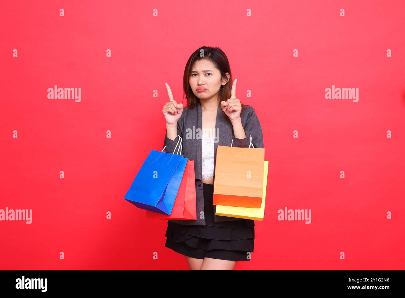 Asian woman pointing upwards hi-res stock photography and images - Alamy