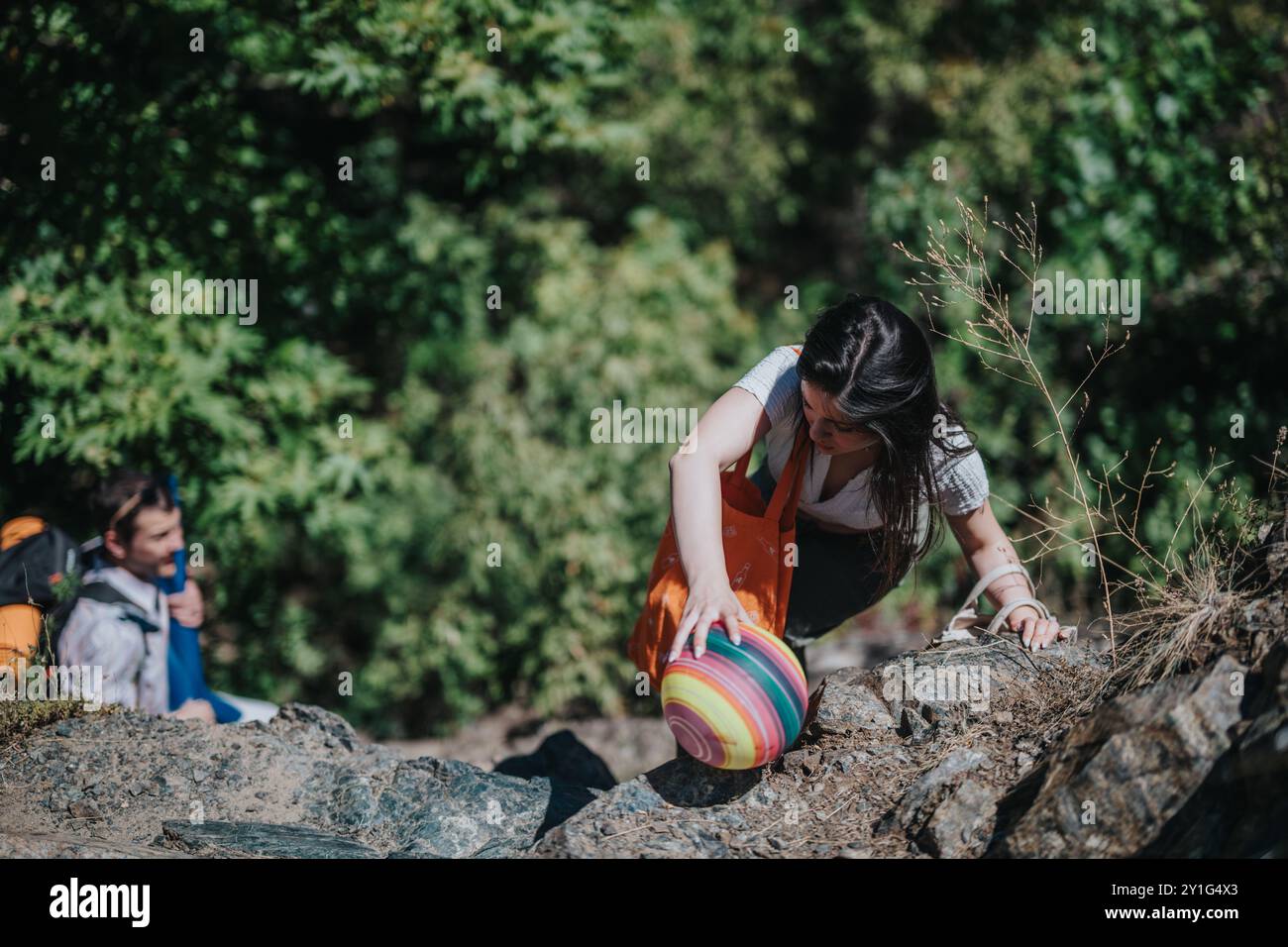 Woman climbing steep rocky hi-res stock photography and images - Alamy