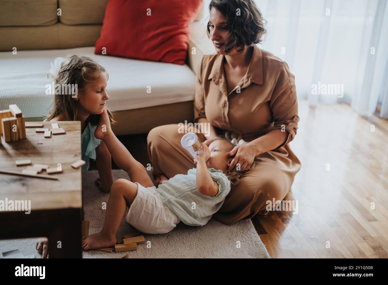 Mother and daughters spending quality time together at home Stock Photo