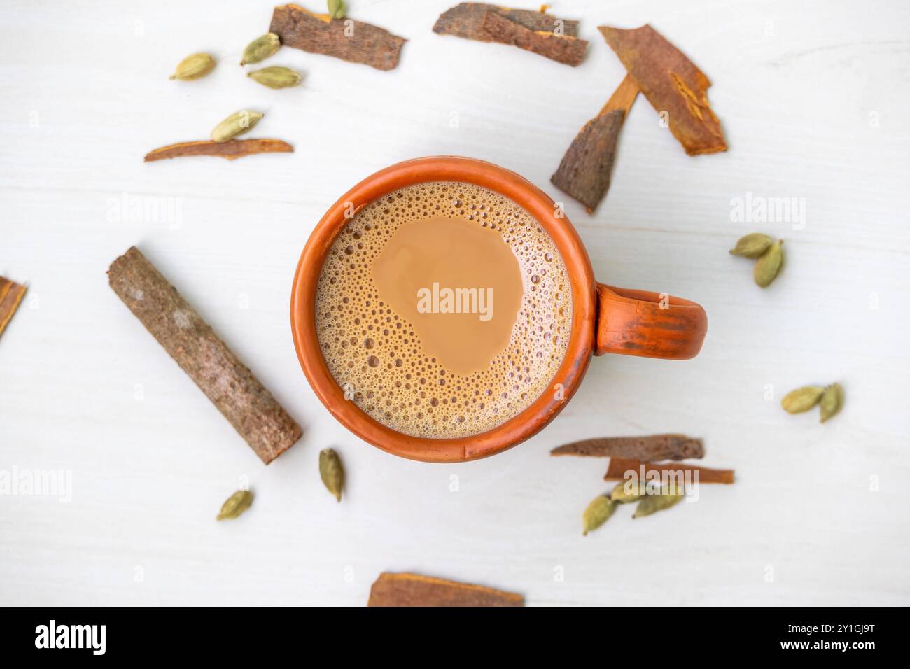 A cup of hot masala tea or masala chai in a natural clay cup. Kullad chai or clay pot tea, is a traditional way of serving masala chai. Top view. Stock Photo