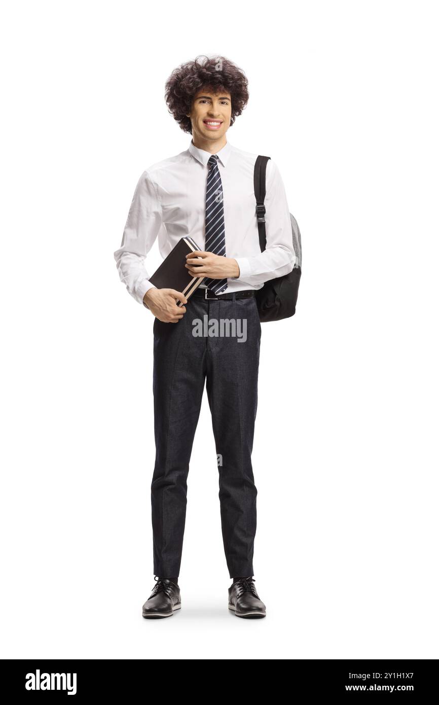 College student holding a book and carrying a backpack isolated on white background Stock Photo