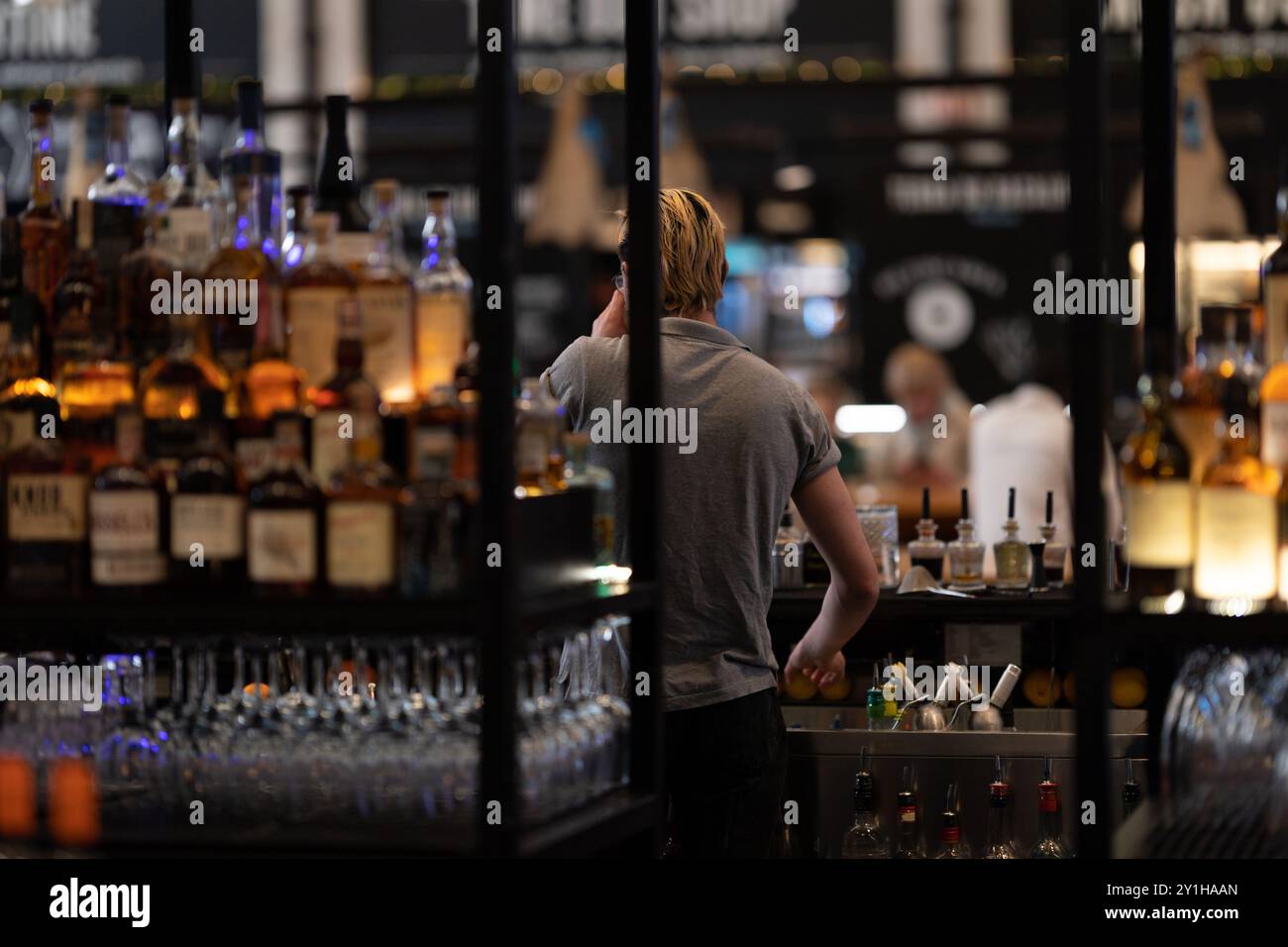 Bartender works in the bar at the restaurant - view from the back Stock ...