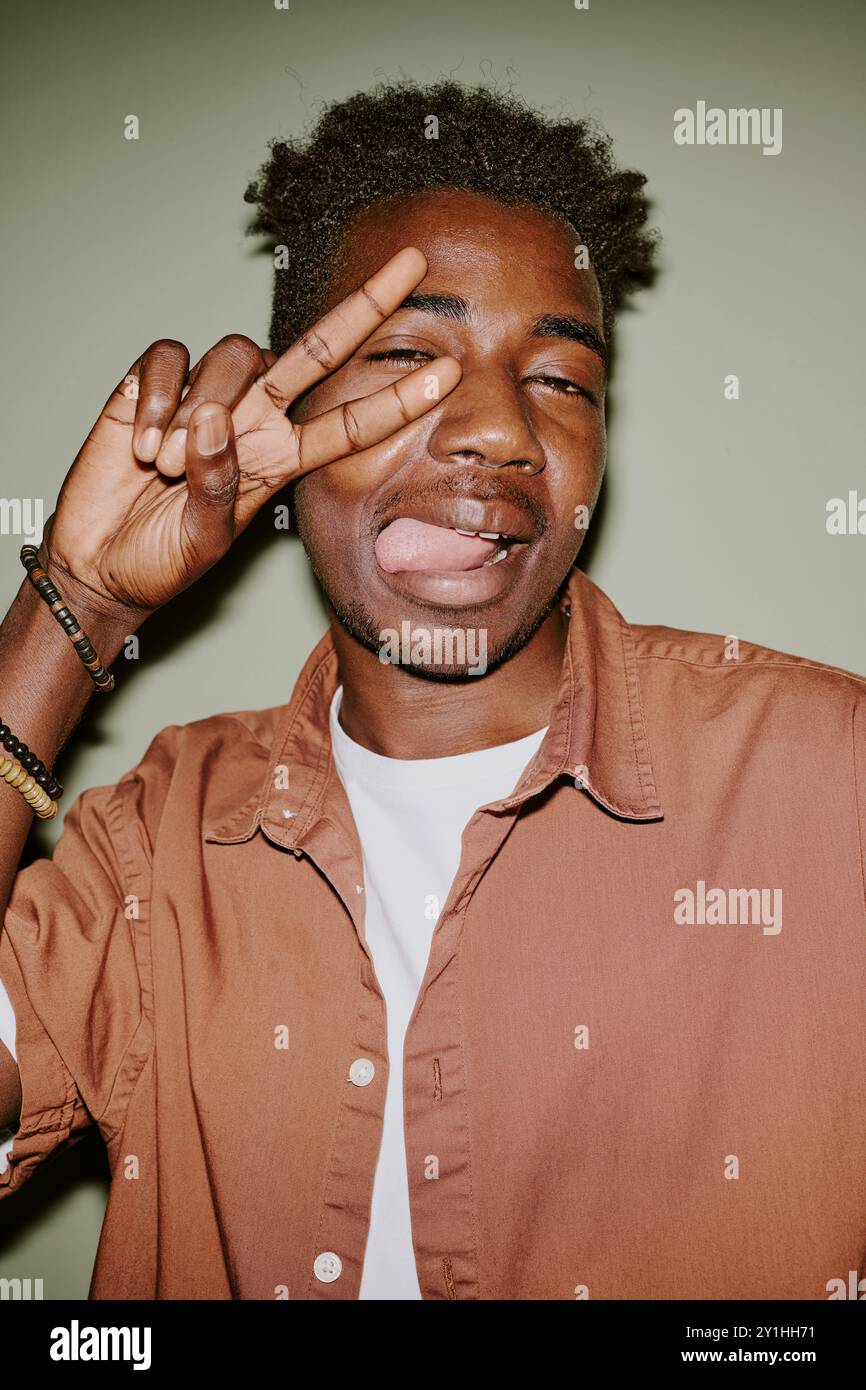 Young black man making faces while posing for photo Stock Photo