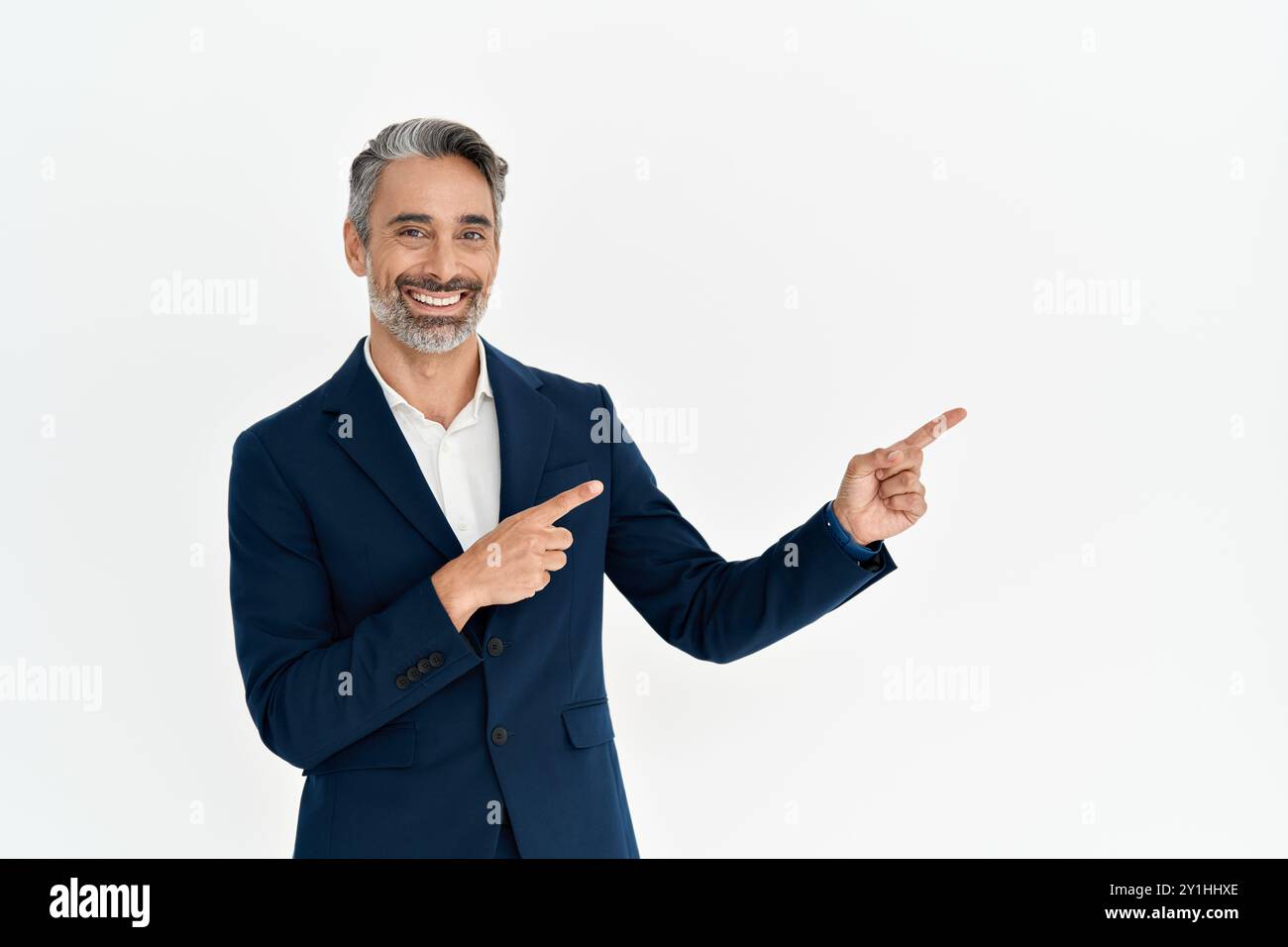 Happy mature business man ceo pointing aside advertising isolated on white. Stock Photo