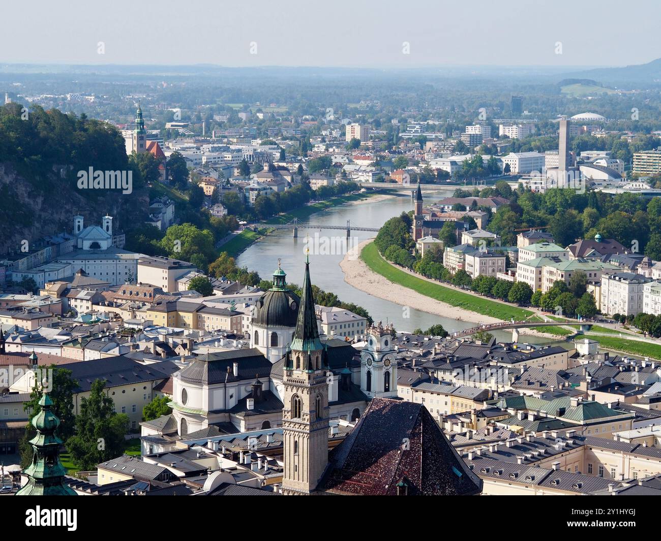 Salzburg, Austria - 31 Aug, 2024: This image showcases a panoramic view of a cityscape with rivers running through it, prominent churches, and various Stock Photo