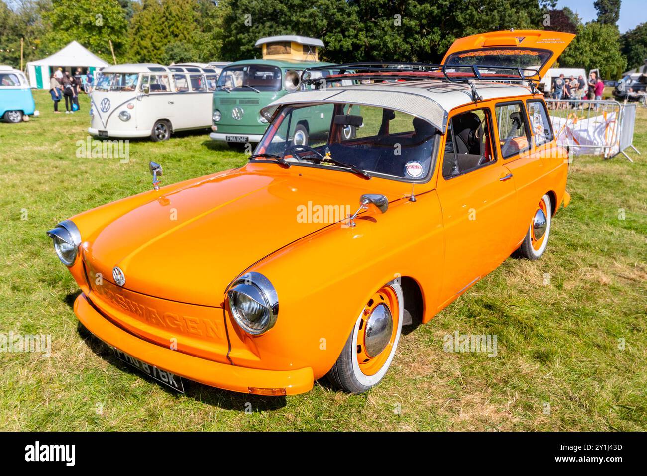 Vintage orange Type 3 volkswagen station wagon car displayed at an