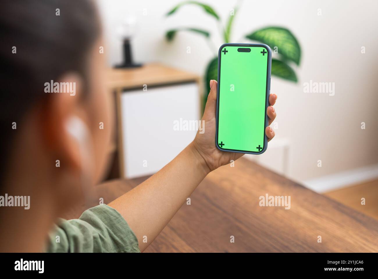 Telehealth Appointment: woman connecting with doctor online call on smartphone chroma key screen Stock Photo