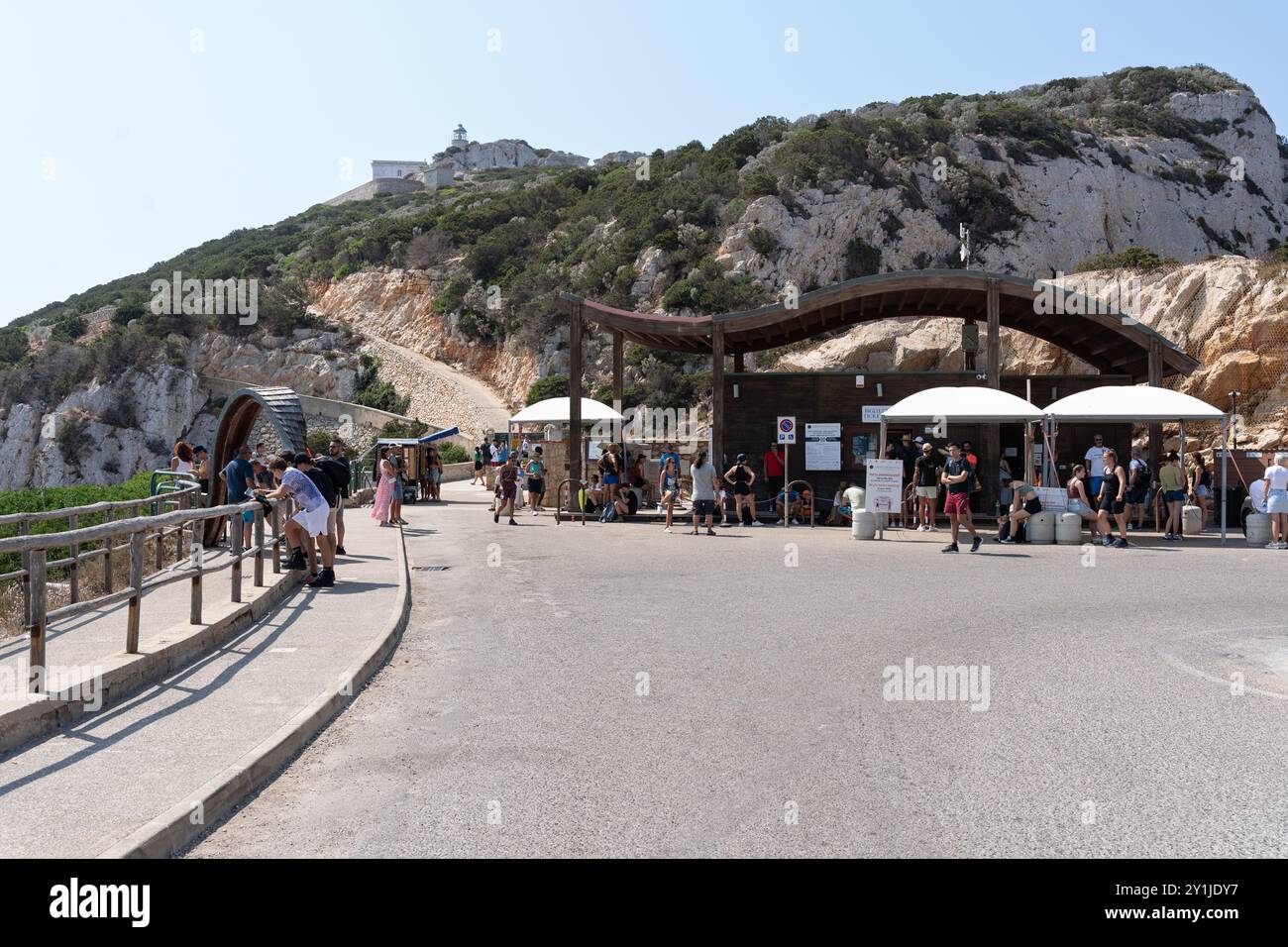 Alghero, Italy - August 25, 2023: Neptune's Grotto (Grotta di Nettuno) ticket offices near Alghero in Sardinia island, with tourist people in the a po Stock Photo