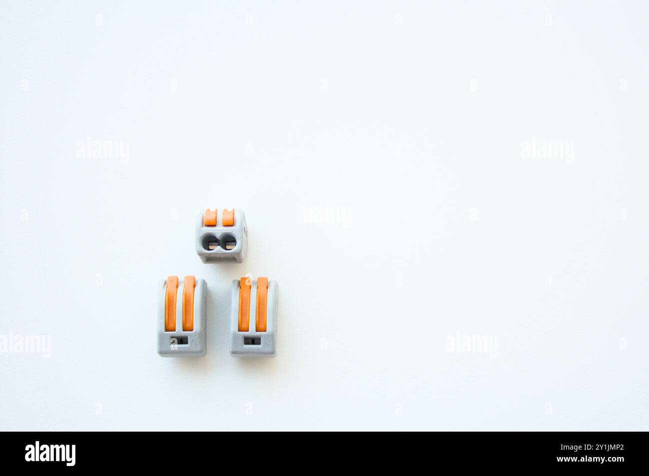 Three quick wiring cable connectors for electrical installations isolated on white background.Wire splice connectors terminals. Copy space available. Stock Photo