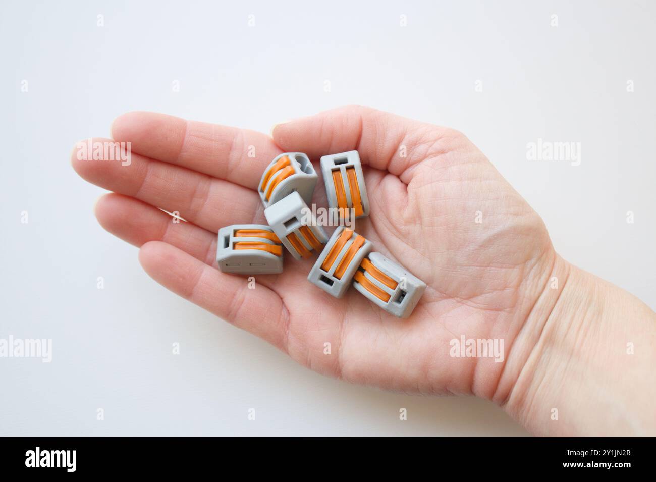 Quick wiring cable connectors for electrical installations. Terminals for quick connection held in a caucasian hand. Wire splice connectors. Stock Photo