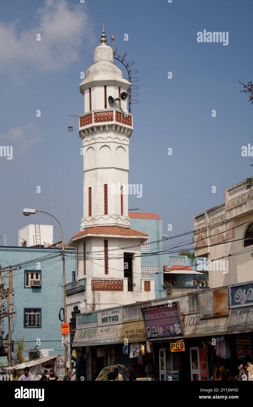 Street scene with Minaret, Puducherry, Pondicherry, Tamil Nadu, India - shops; minaret; mosque; beautiful, white minaret with some brown details. Stock Photo