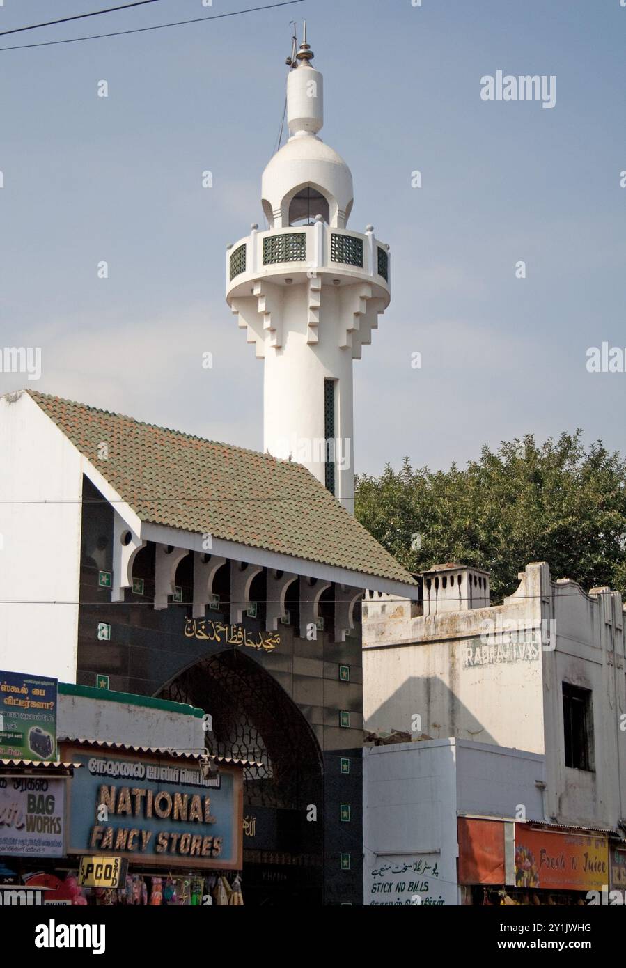 Street scene with Minaret, Puducherry, Pondicherry, Tamil Nadu, India - shops; minaret; mosque; beautiful, white minaret with some green details;  Isl Stock Photo