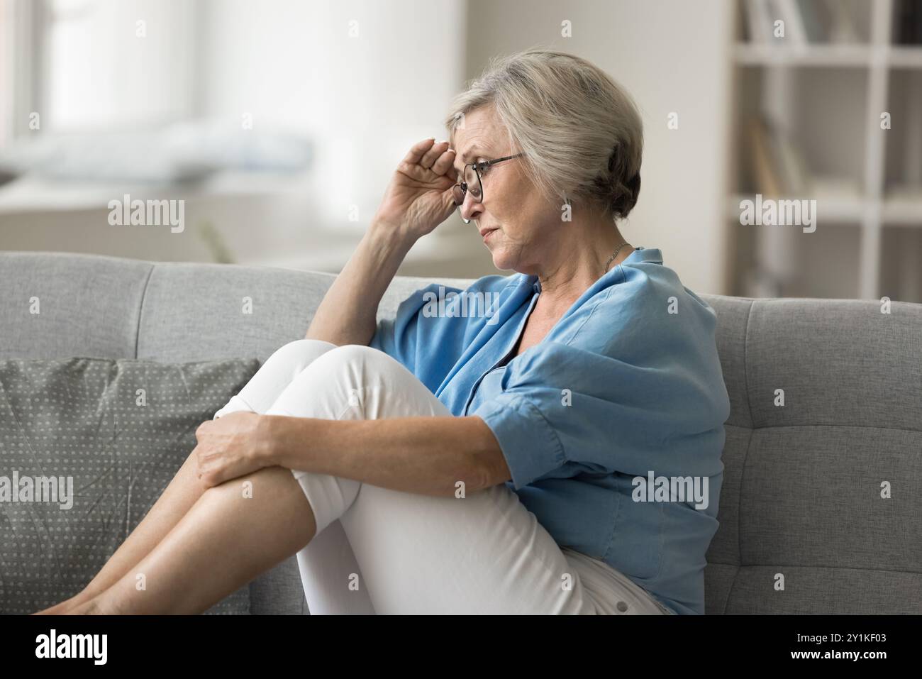 Woman sad alone sofa hi-res stock photography and images - Alamy