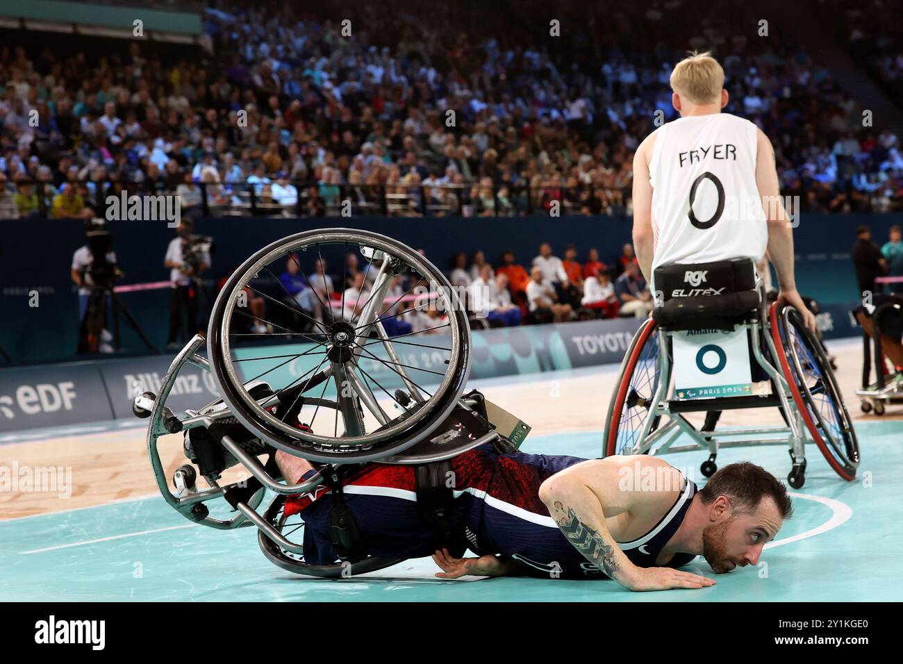Steve Serio of the U.S lies on the ground during the wheelchair
