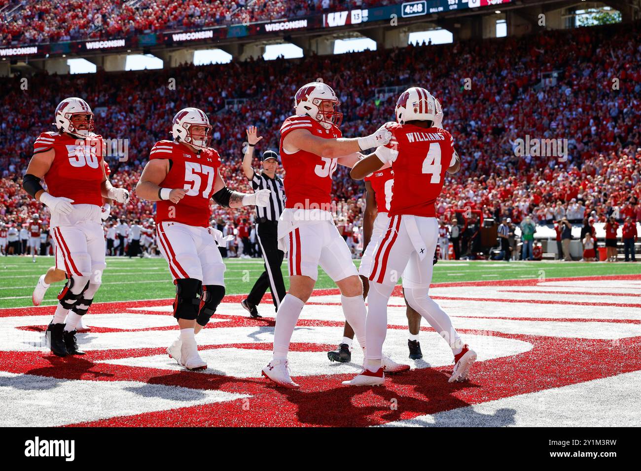 September 7, 2024: Wisconsin Badgers wide receiver C.J. Williams (4) celebrates his 50 yard touchdown reception with tight end Tucker Ashcraft (38), offensive lineman Jake Renfro (57), and offensive lineman Joe Brunner (56) during the NCAA Football game between the South Dakota Coyotes and the Wisconsin Badgers at Camp Randall Stadium in Madison, WI. Darren Lee/CSM. Stock Photo