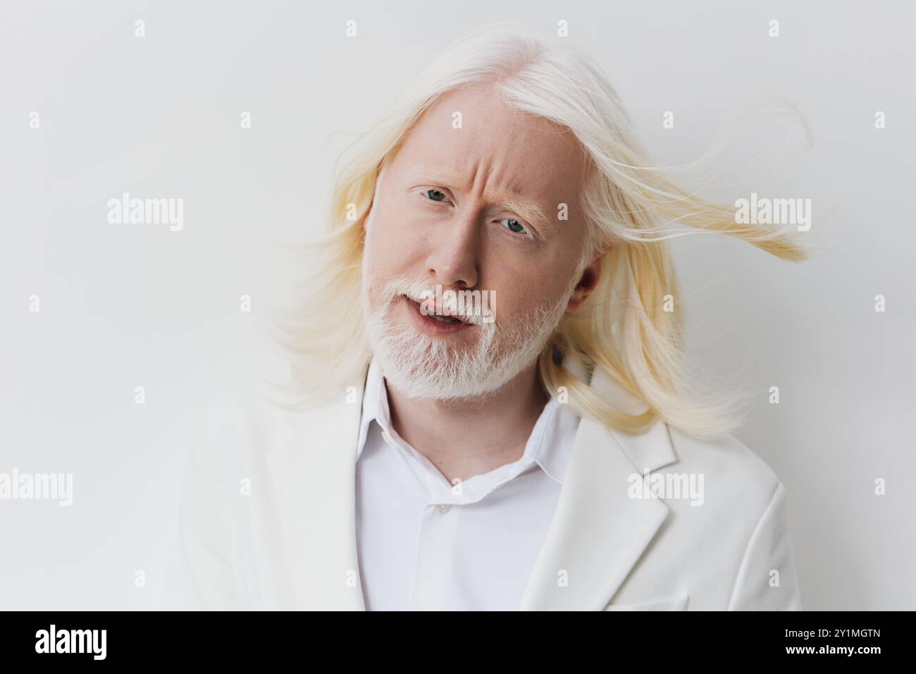Portrait of a man with long white hair and beard, wearing a stylish ...