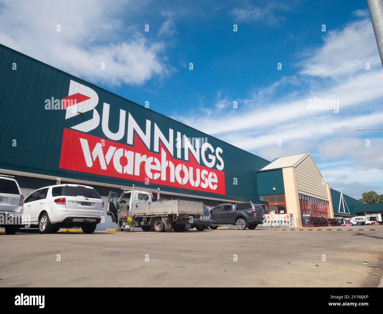 Exterior view of Bunnings Warehouse hardware store on a sunny day with blue sky and white clouds in South Australia, Australia. Stock Photo