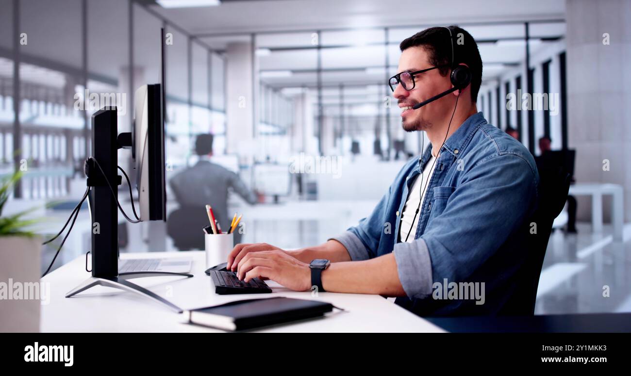 Call Center Operator Sitting Working At Office Stock Photo