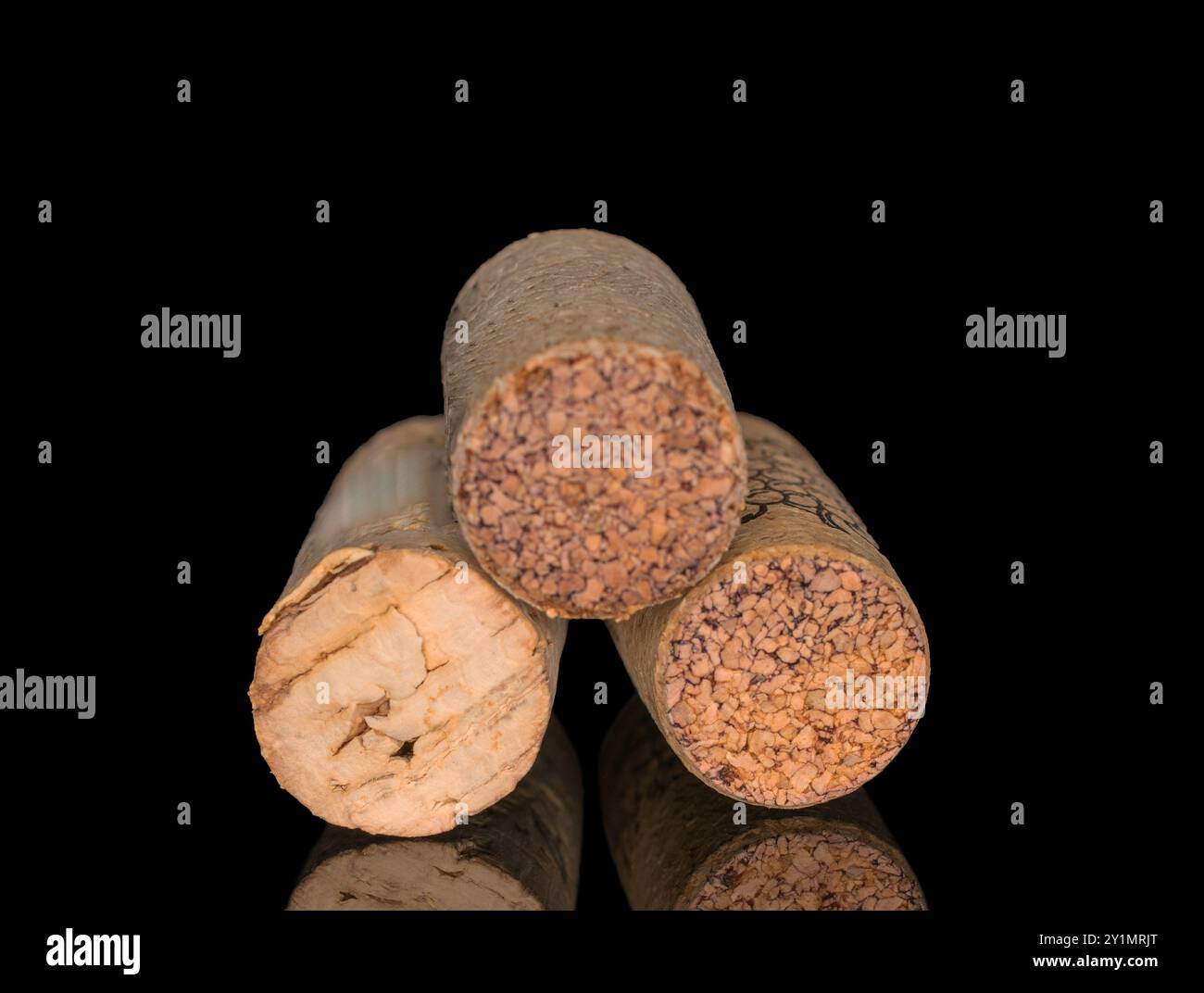 Three wine corks, macro, isolated on black background. Stock Photo