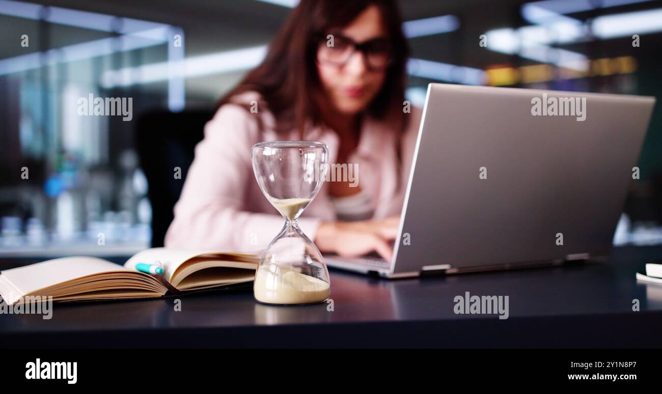 Late Invoice And Billing Deadline With Hourglass At Desk Stock Photo ...
