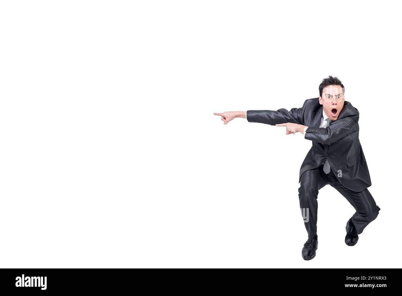 Amazed man pointing aside in studio. White background Stock Photo - Alamy