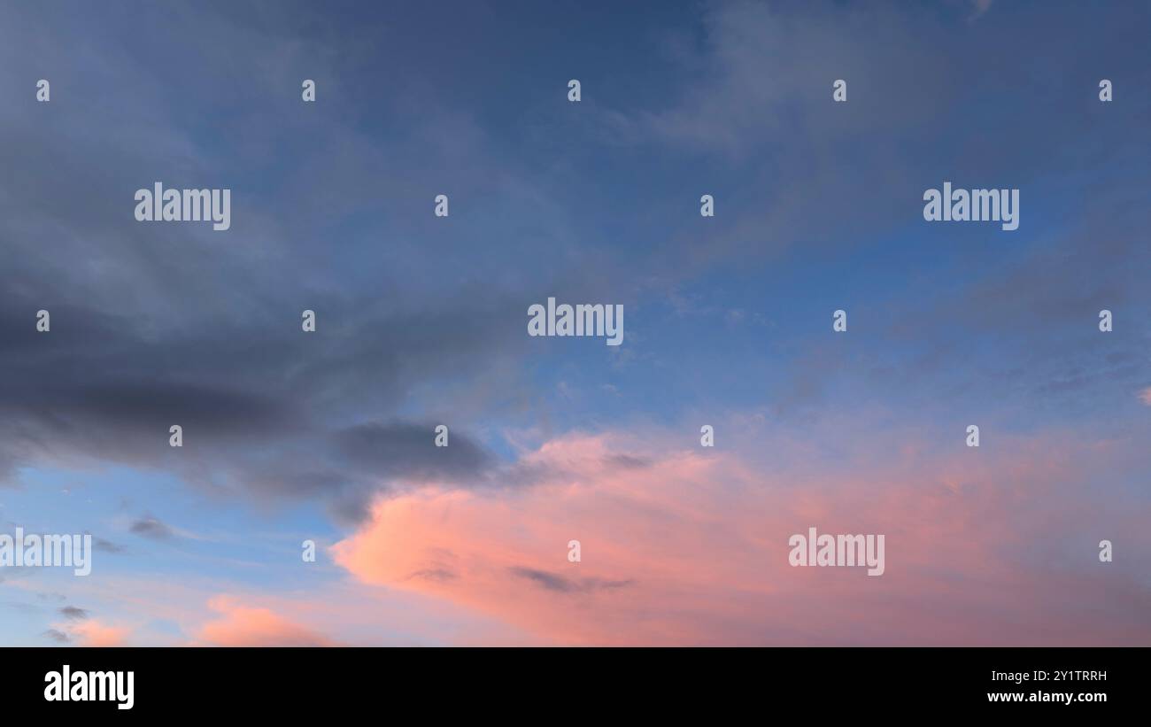 Cloudy sunset dramatic skies background, evening colourful sky template, painted clouds wallpaper Stock Photo