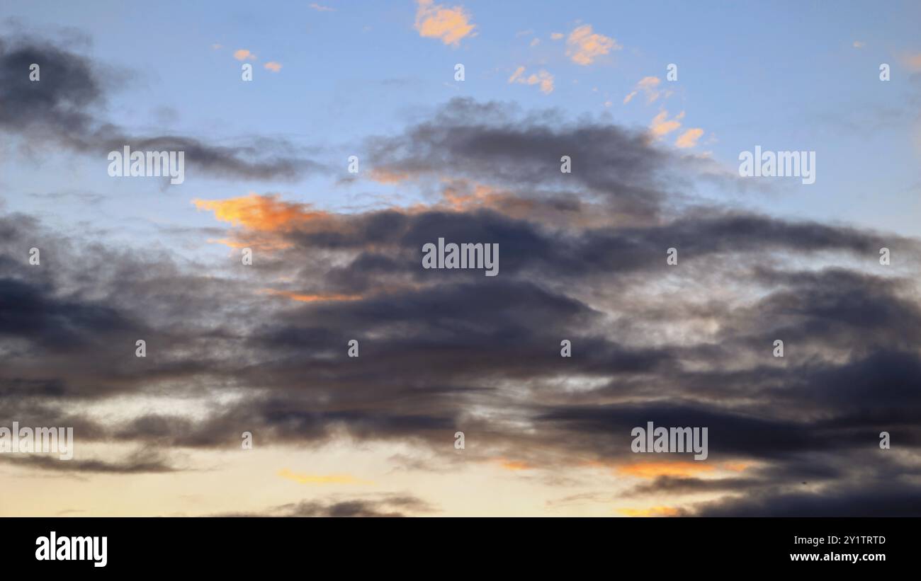Cloudy sunset dramatic skies background, evening colourful sky template, painted clouds wallpaper Stock Photo