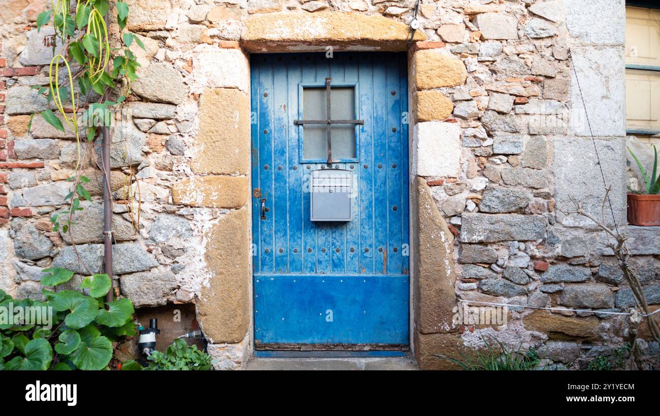 Antique wooden door in a stone house with plants Stock Photo - Alamy
