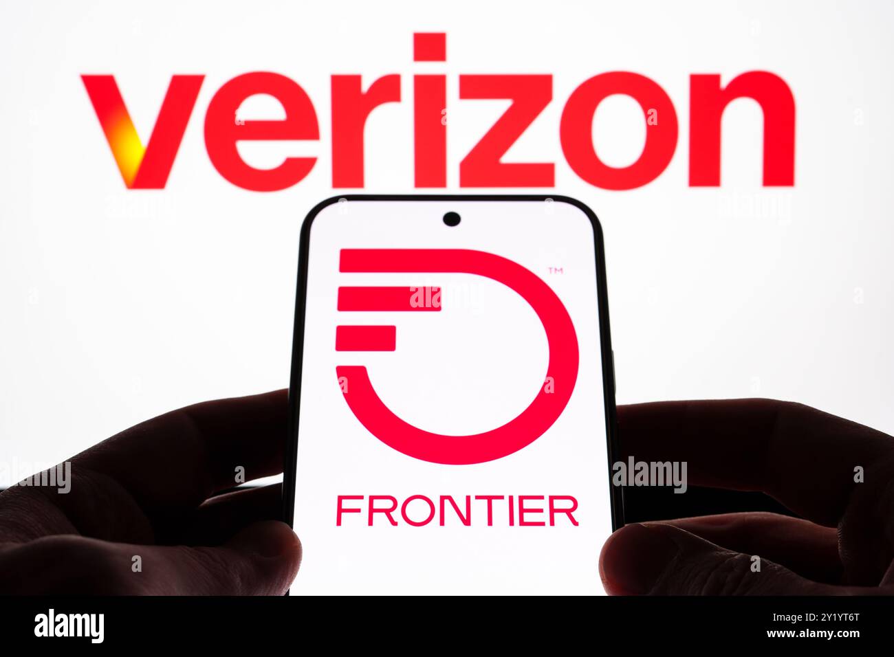 Verizon and Frontier Communications logos displayed on screen devices, emphasizing telecommunications partnership. Stafford, United Kingdom, September Stock Photo