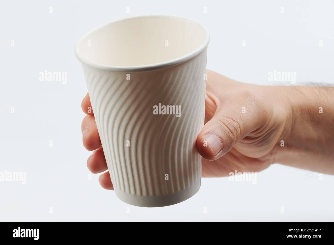 Empty white paper cup in hand with texture for better grip Stock Photo ...