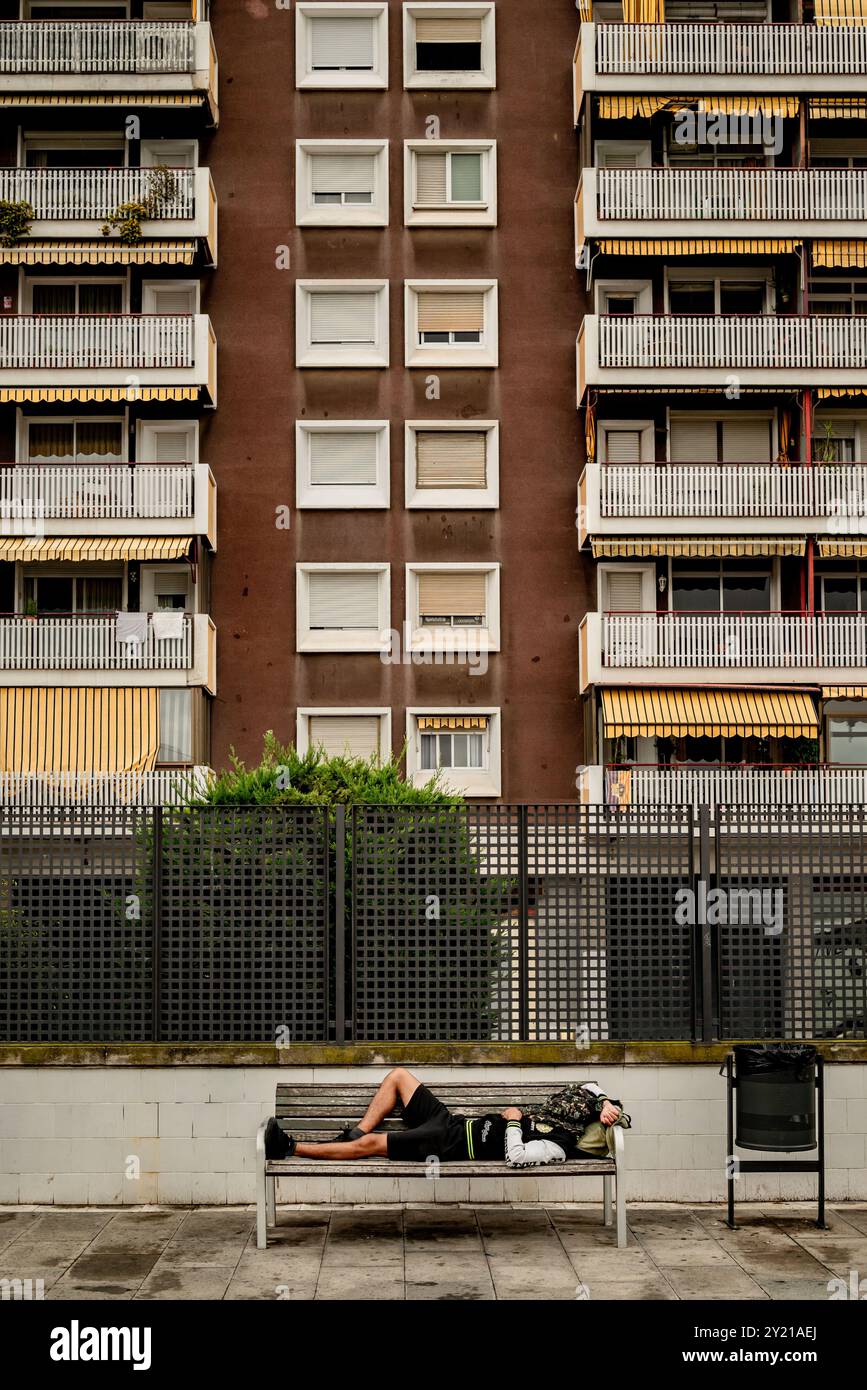 Man rests on a bench of the Espanya Industrial park in the Sants district of Barcelona. Stock Photo