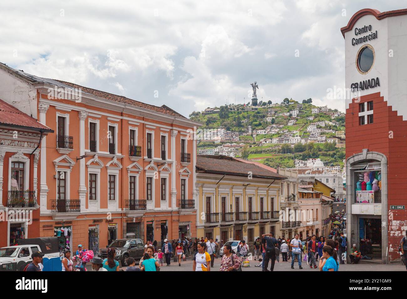 A typical street of downtown and the Virgin de El Panecillo statue on top of  El Panecillio hill in Quito, Ecuador from San Francisco Plaza Stock Photo