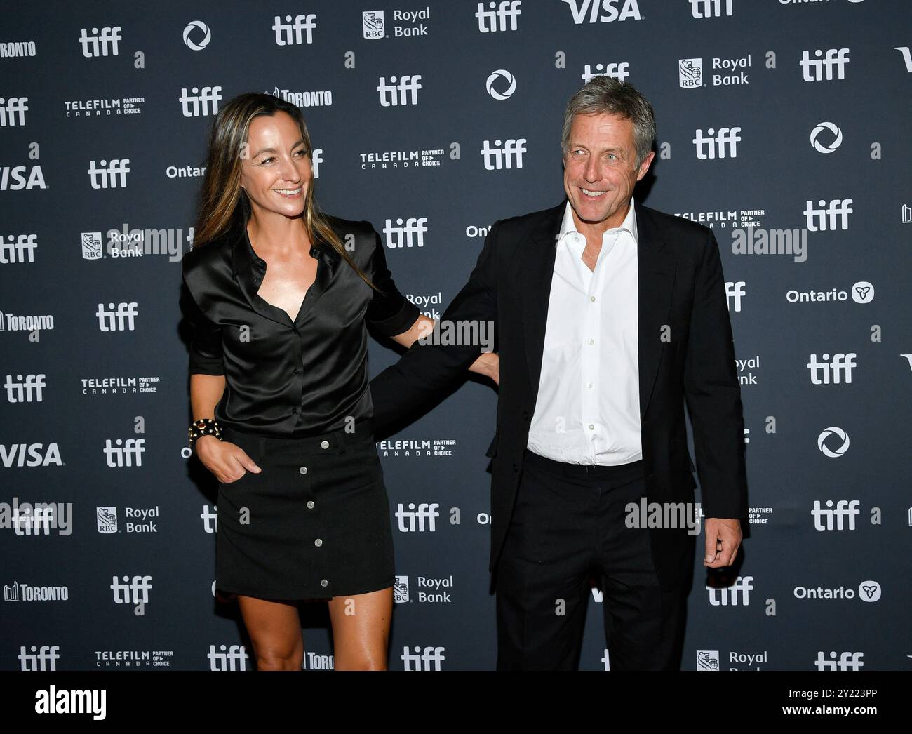 Hugh Grant, right, and wife Anna Elisabet Eberstein attend the 