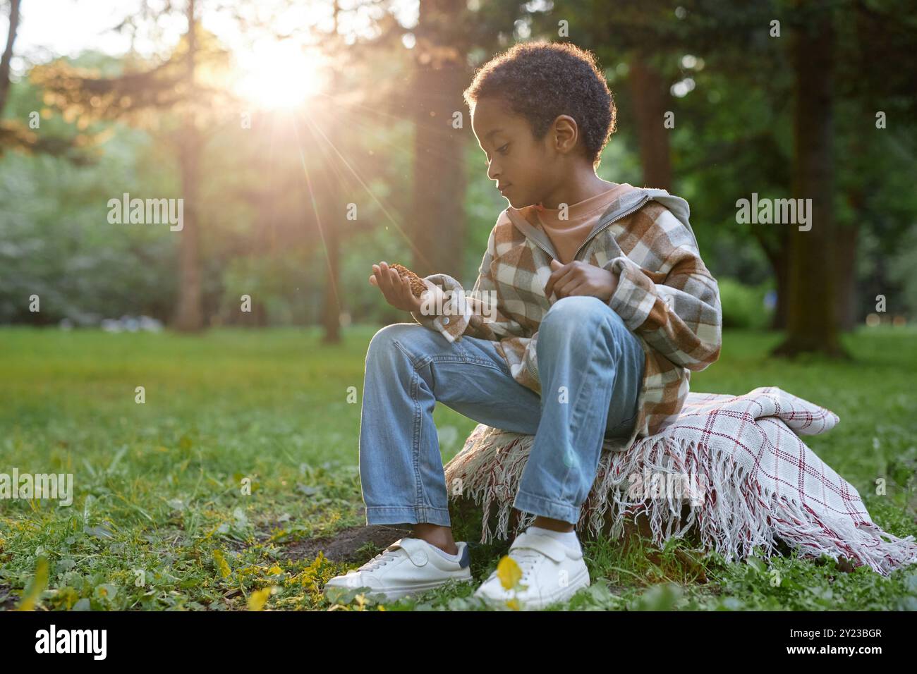 African boy sitting in forest hi-res stock photography and images - Alamy