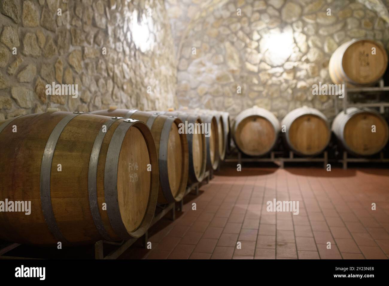 View of Wine cellar with oak barrels for aging wine. Traditional wine storage ...