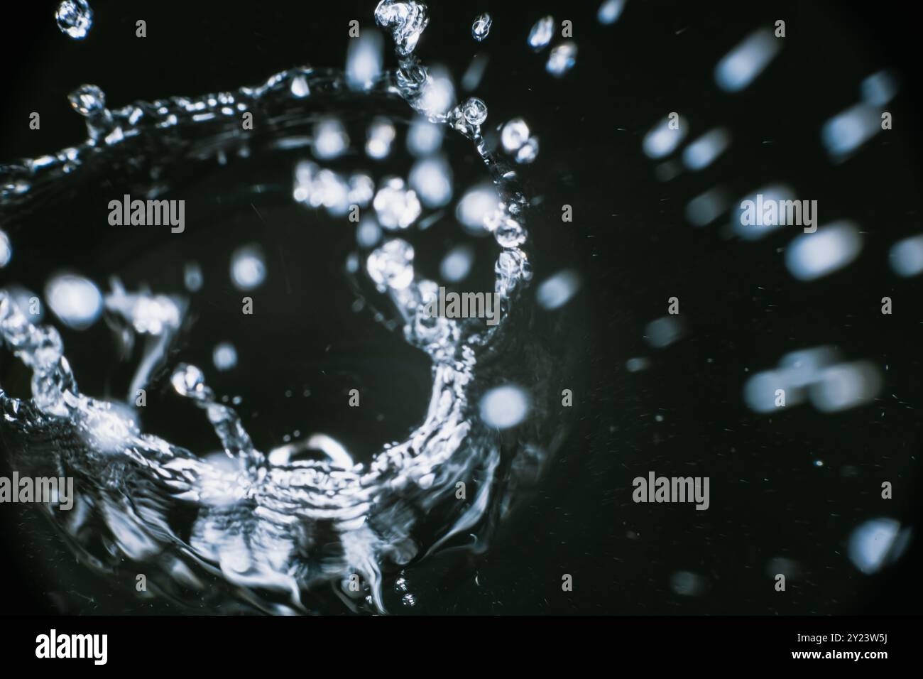Splashes of blue clear water in motion on a black background closeup Stock Photo