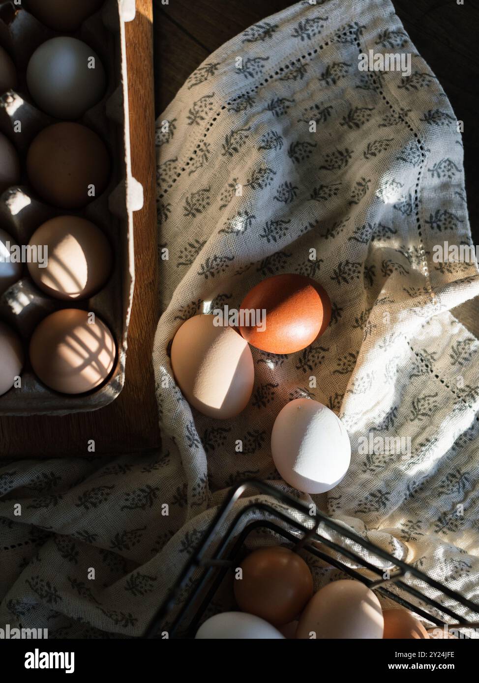 Eggs in a carton and basket with soft shadows Stock Photo
