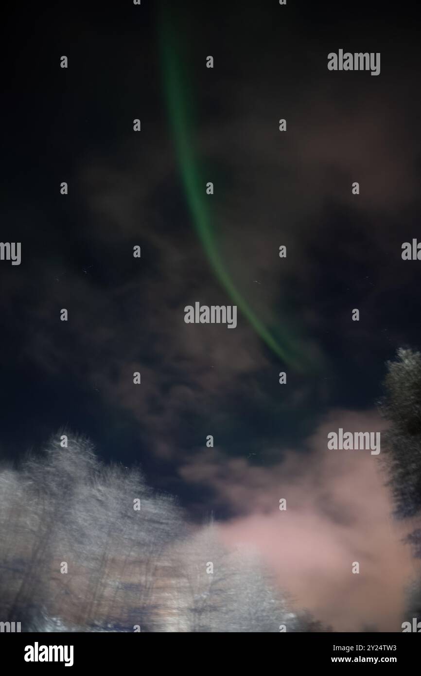 Green northern lights in night sky in Rovaniemi, Lapland Stock Photo