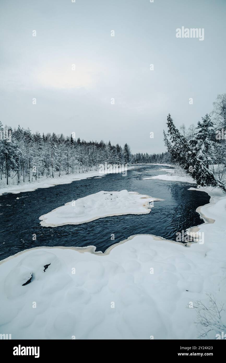 Semi frozen arctic river in snowy forest in Rovaniemi, Lapland Stock ...