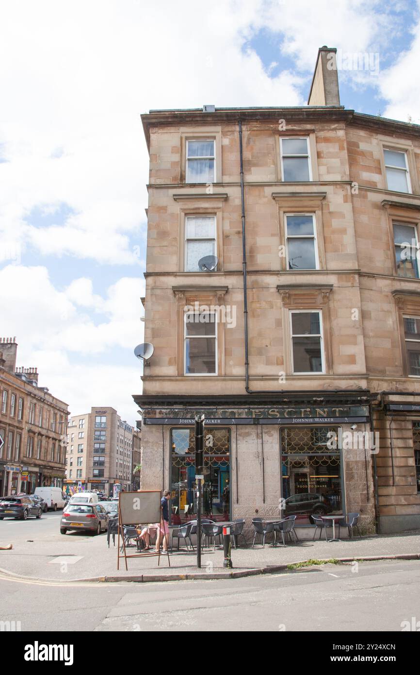 A city scene with people drinking outside a restaurant bar in Finnieston, Glasgow, Scotland in the UK Stock Photo